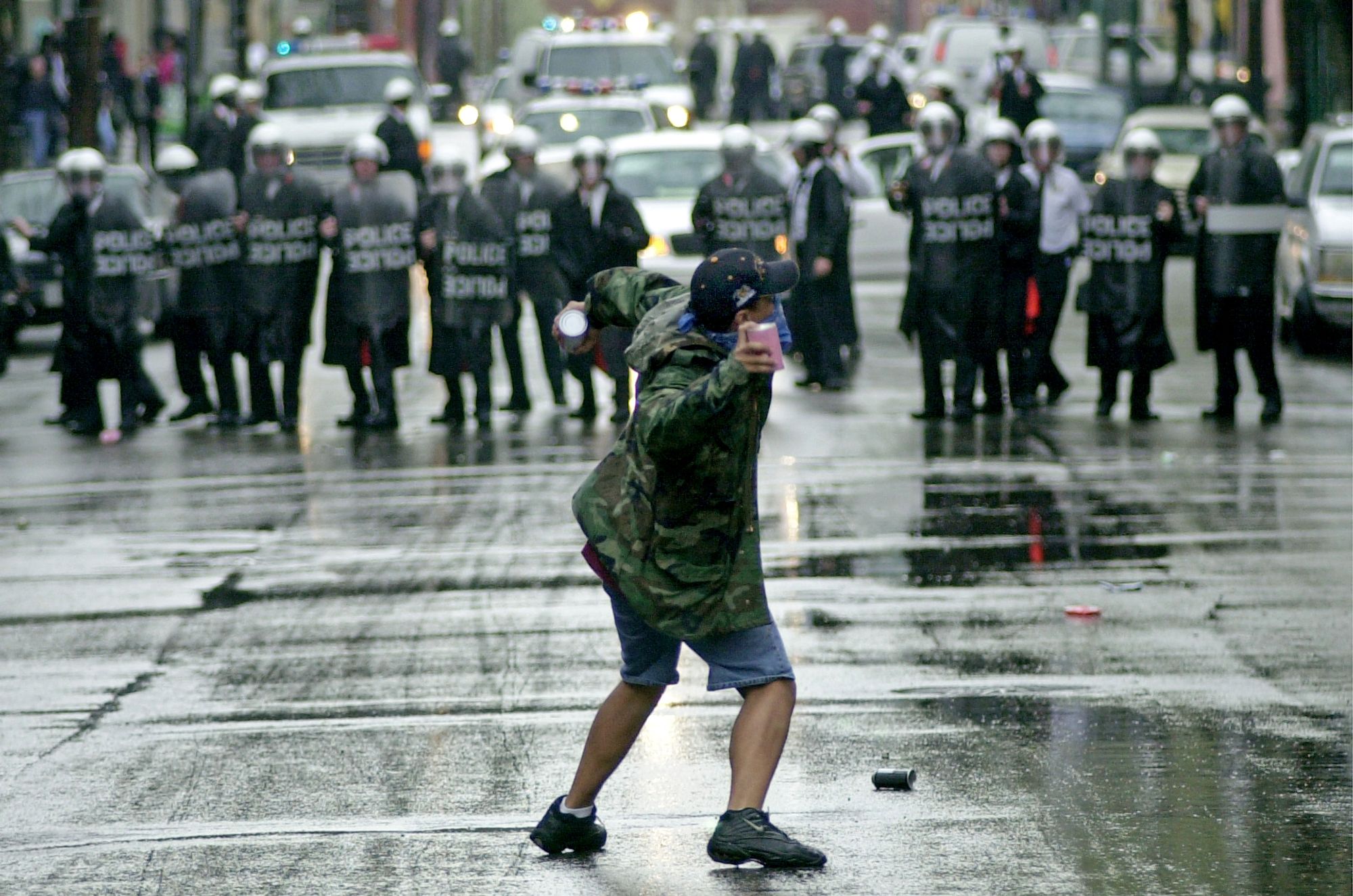 387726 01: A protester throws debris April 10, 2001 at Cincinnati Police Officers in riot gear in the Over The Rhine area in Downtown Cincinnati. African American protesters took to the streets to protest the shooting of an unarmed African American over this past weekend who was wanted for several misdemeanors and traffic violations. (Photo by Mike Simons/Newsmakers)