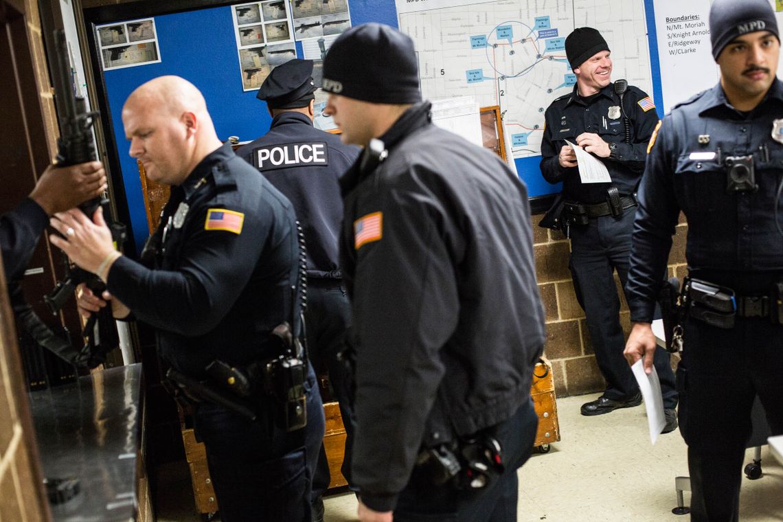 Officers check out firearms before the start of their shift at the Mt. Moriah Station in East Memphis. 