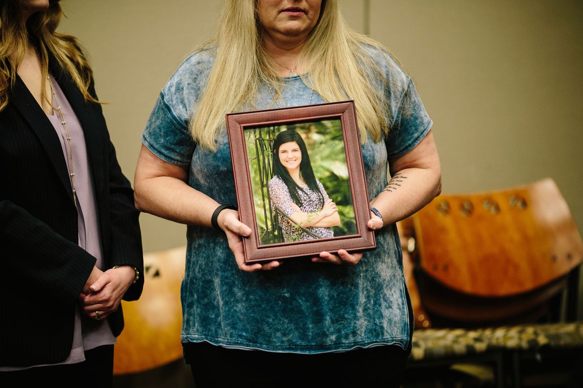 Jamie Reavis, of Jefferson Parish, Louisiana, holds a photograph of her daughter during a meeting of the Louisiana Crime Victims Reparations Board in May. Reavis's daughter Taylor Friloux was murdered during a robbery at a fast-food restaurant where she worked.