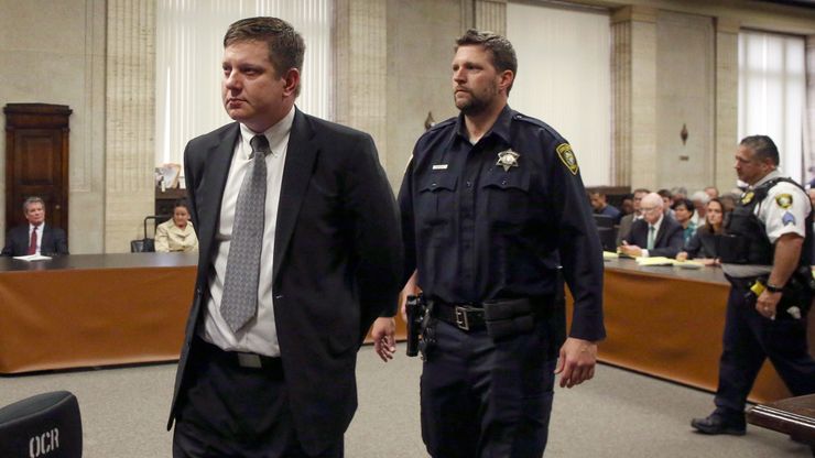 Former Chicago police officer Jason Van Dyke, left, is taken into custody after jurors found him guilty of second-degree murder in the 2014 shooting of teenager Laquan McDonald.