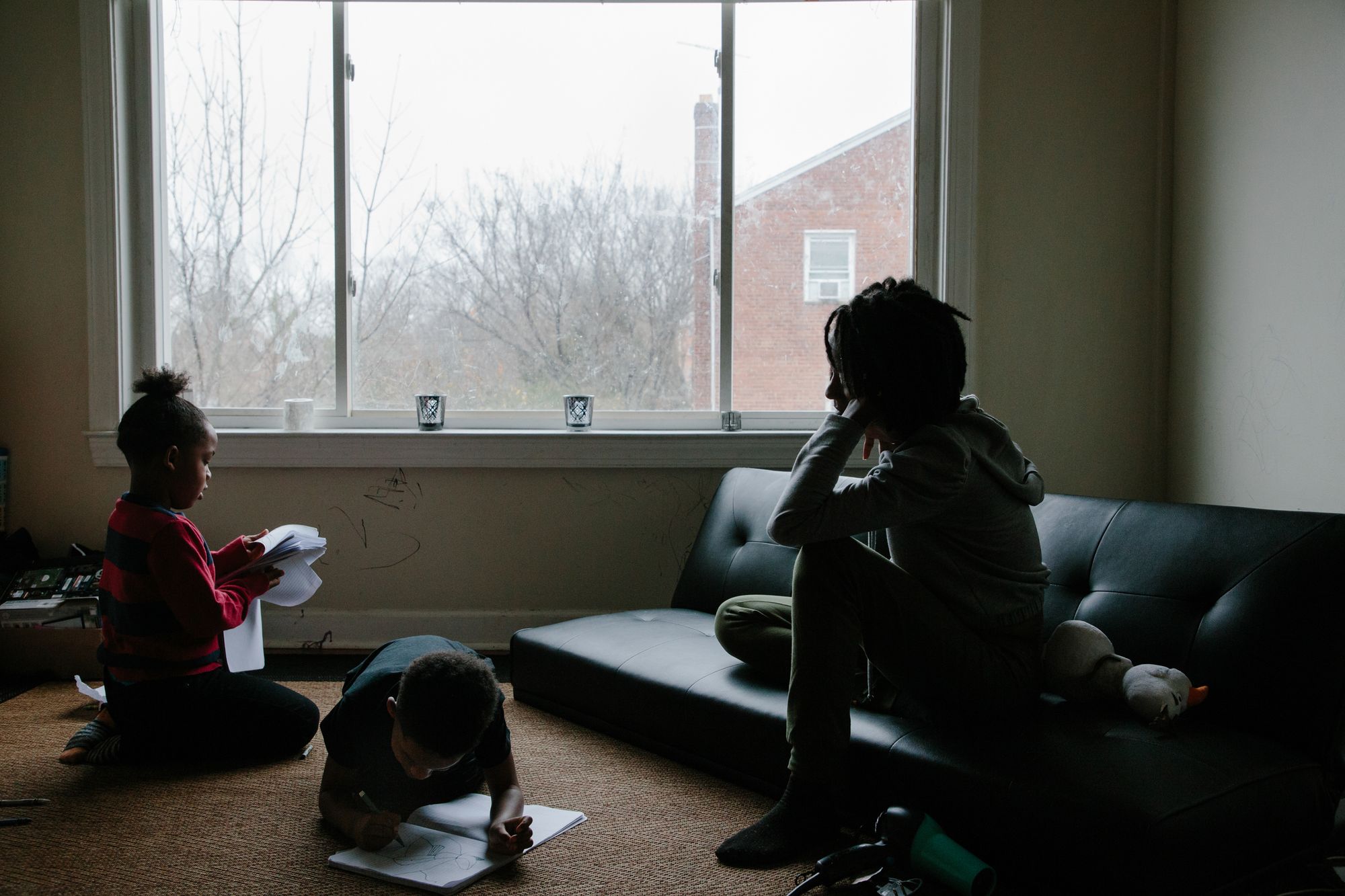 Chaney (right), looks on as her twin boys, Blake (left), and Bryce (right), color in journals on Dec. 16, 2020. After her mother’s release in 2011, the disconnect Chaney felt with her mother made it hard for her to connect with her own children. 