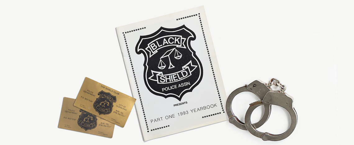 From left, Black Shield Club business cards, a Black Shield yearbook and handcuffs. 