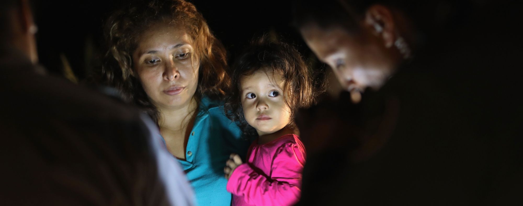 Central American asylum seekers, including a Honduran girl, 2, and her mother, are taken into custody near the U.S.-Mexico border in June in McAllen, Texas. 