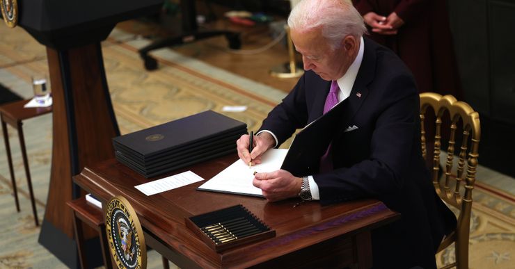 President Joe Biden signs an executive order at the White House in Washington, on Jan. 21. 