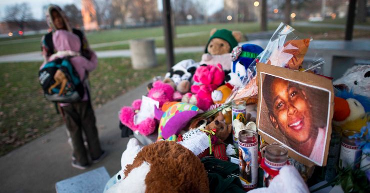 CLEVELAND, OHIO DECEMBER 4, 2014:..Kiara Jacobs, 8, hugs her brother Quentin Stamen, 13, at a makeshift memorial site dedicated to Tamir Rice at Cudell Coms Park, the park where the 12 year-old boy was shot to death by police, on Thursday, December 4, 2014. The memorial is made up of toys, a few pictures and letters and drawings from friends.