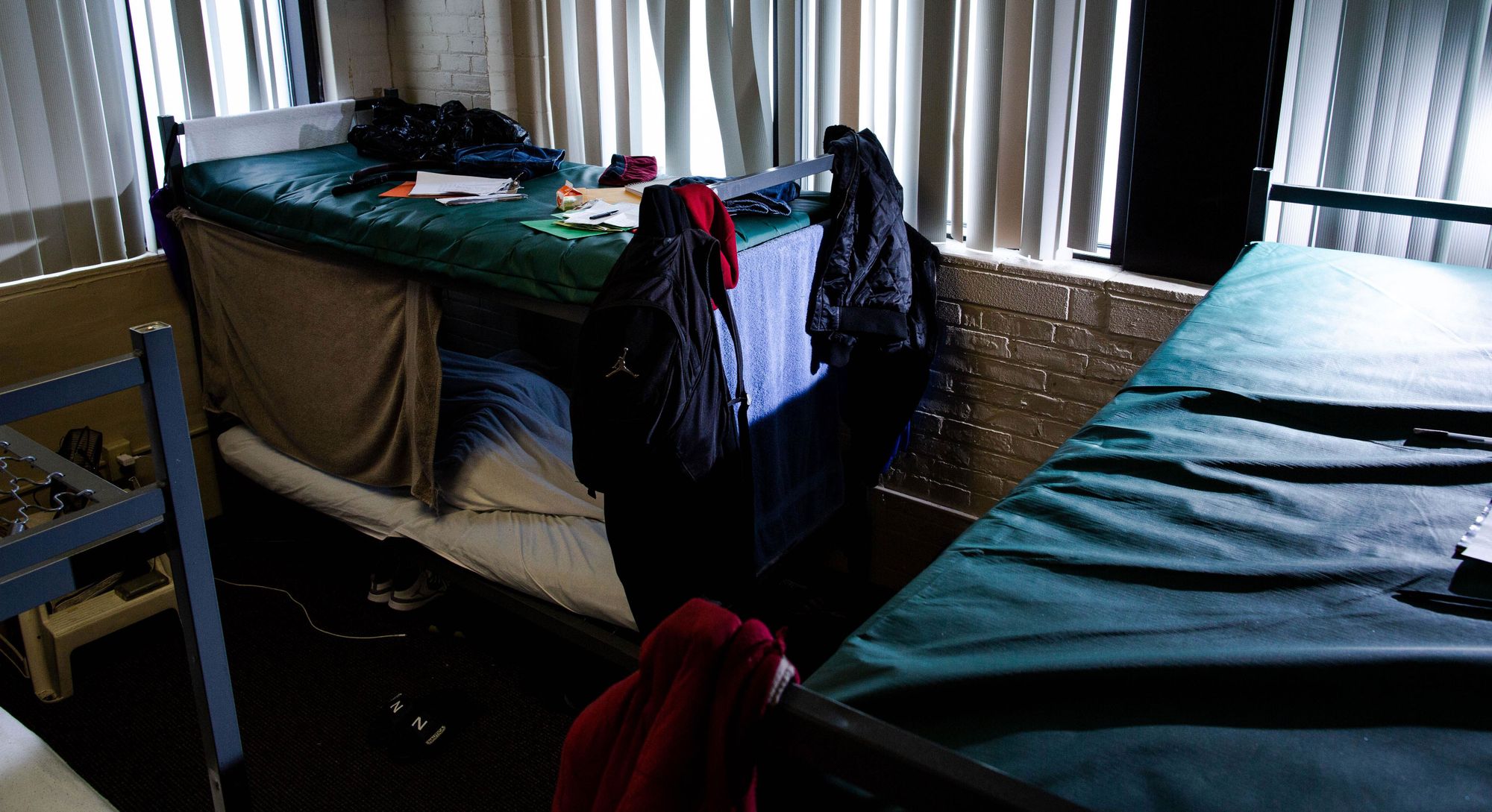 A man sleeps inside the dormitory at Fannie M. Lewis Community Corrections and Treatment Center, a halfway house for federal inmates, in Cleveland, Ohio.