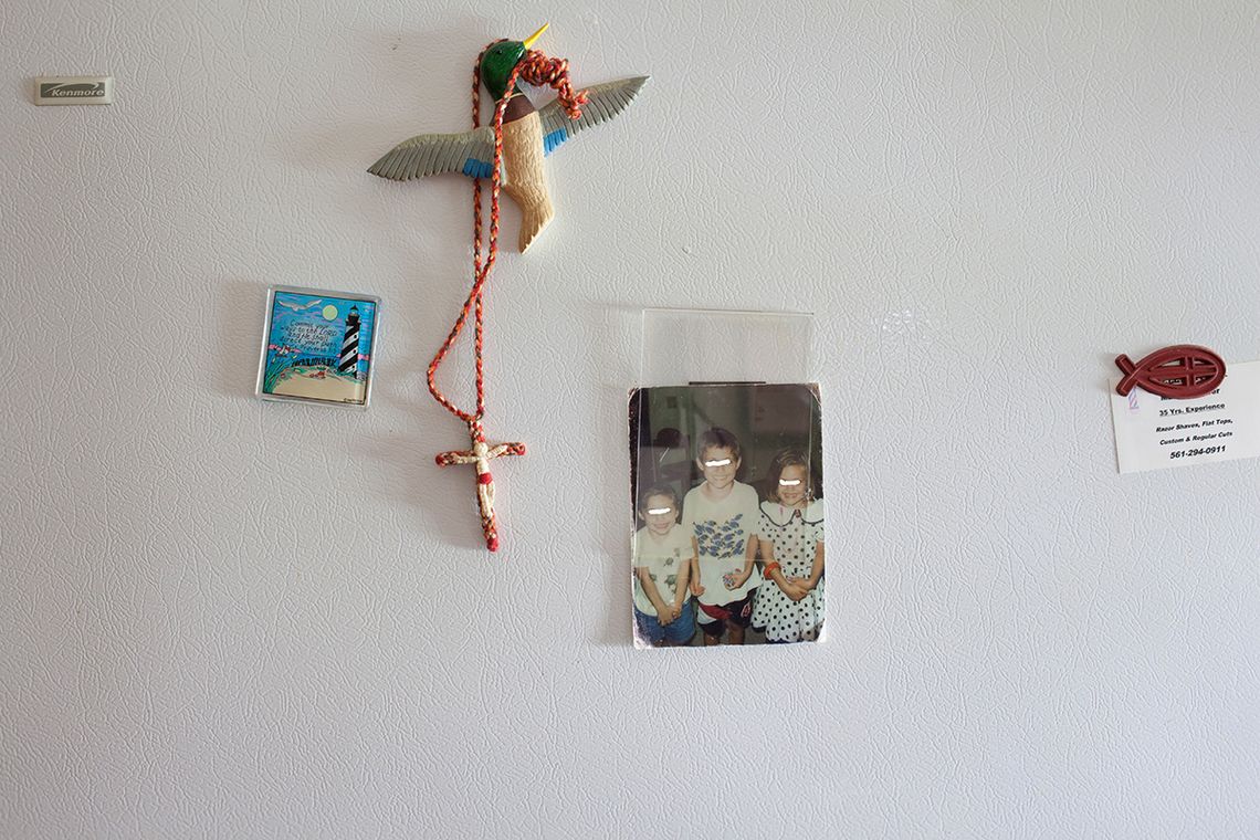 Objects on Rose's refrigerator include a photograph of her children (their eyes were obscured by the photographer to protect their identities).
