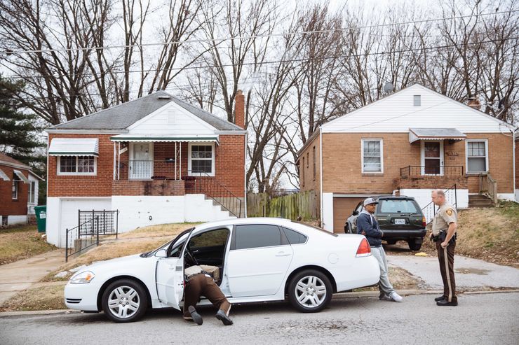 St. Louis County police officers Thomas Keener performing a search during a stop just outside the area designated as having a high risk of aggravated assault. 