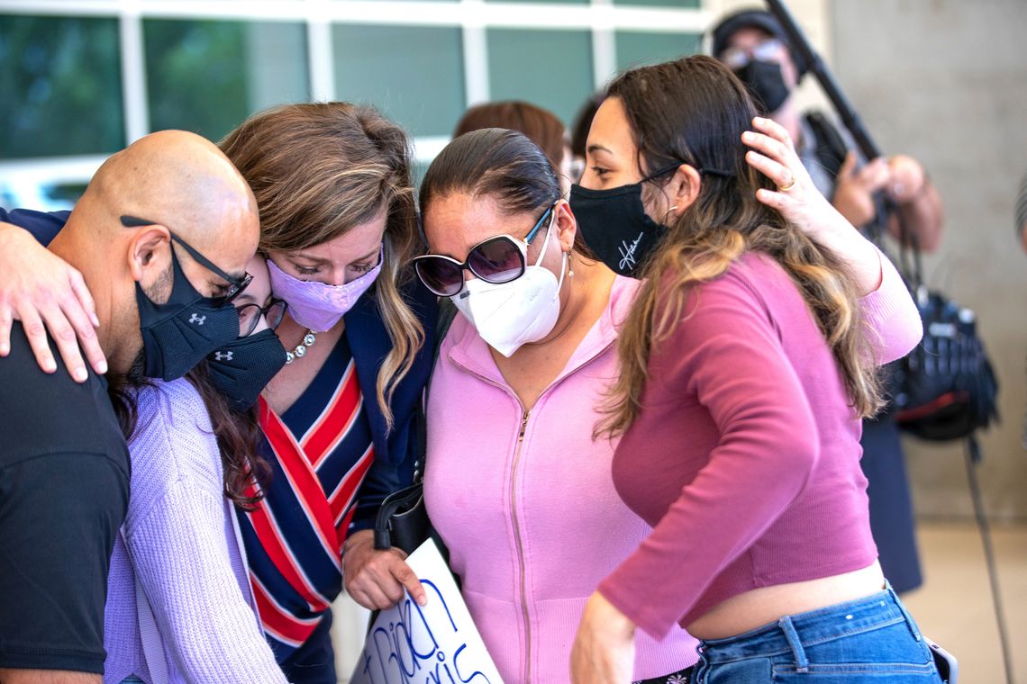 Alejandra Juarez hugs her daughter Pamela Juarez, right, her lawyer Andrea Martinez, daughter Estela Juarez, and husband Temo Juarez, left, after returning to Orlando International Airport in Orlando, Fla., in May 2021.