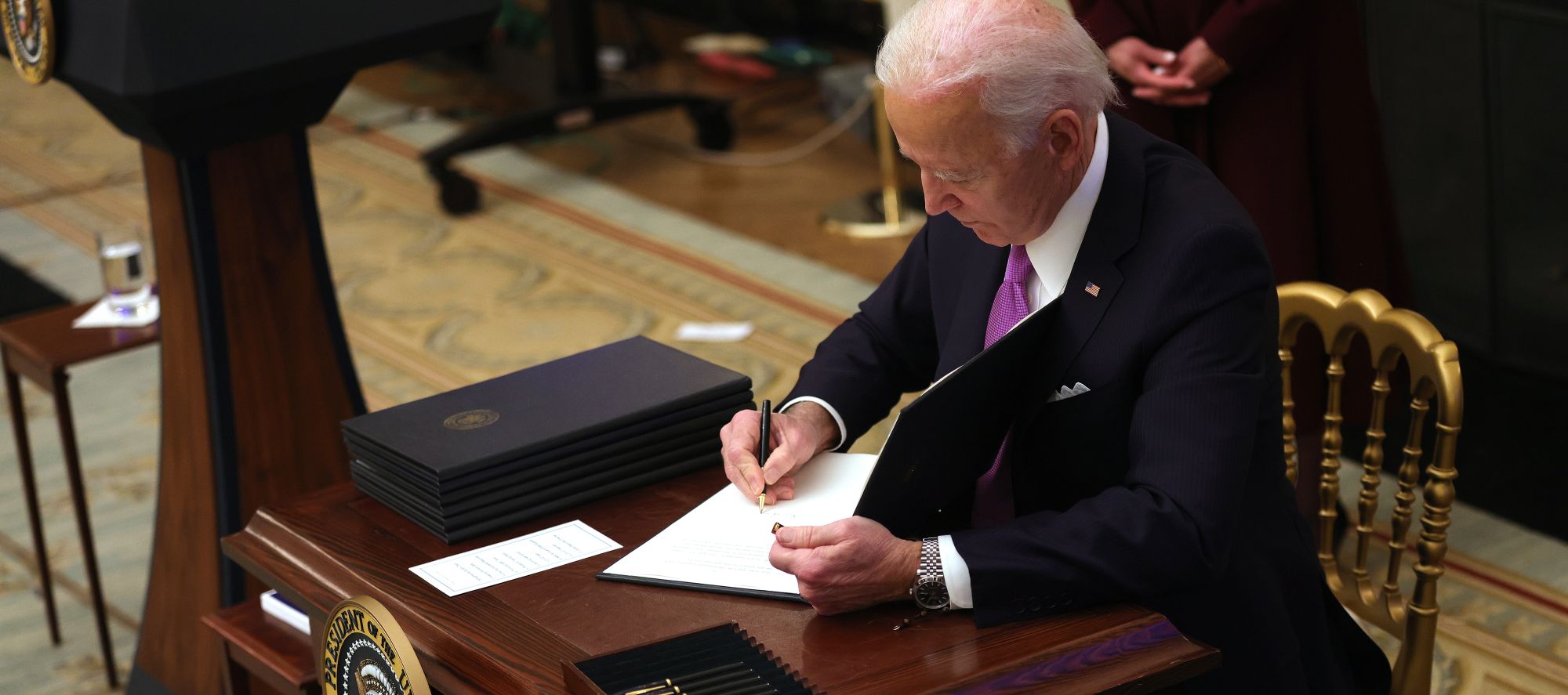 President Joe Biden signs an executive order at the White House in Washington, on Jan. 21. 