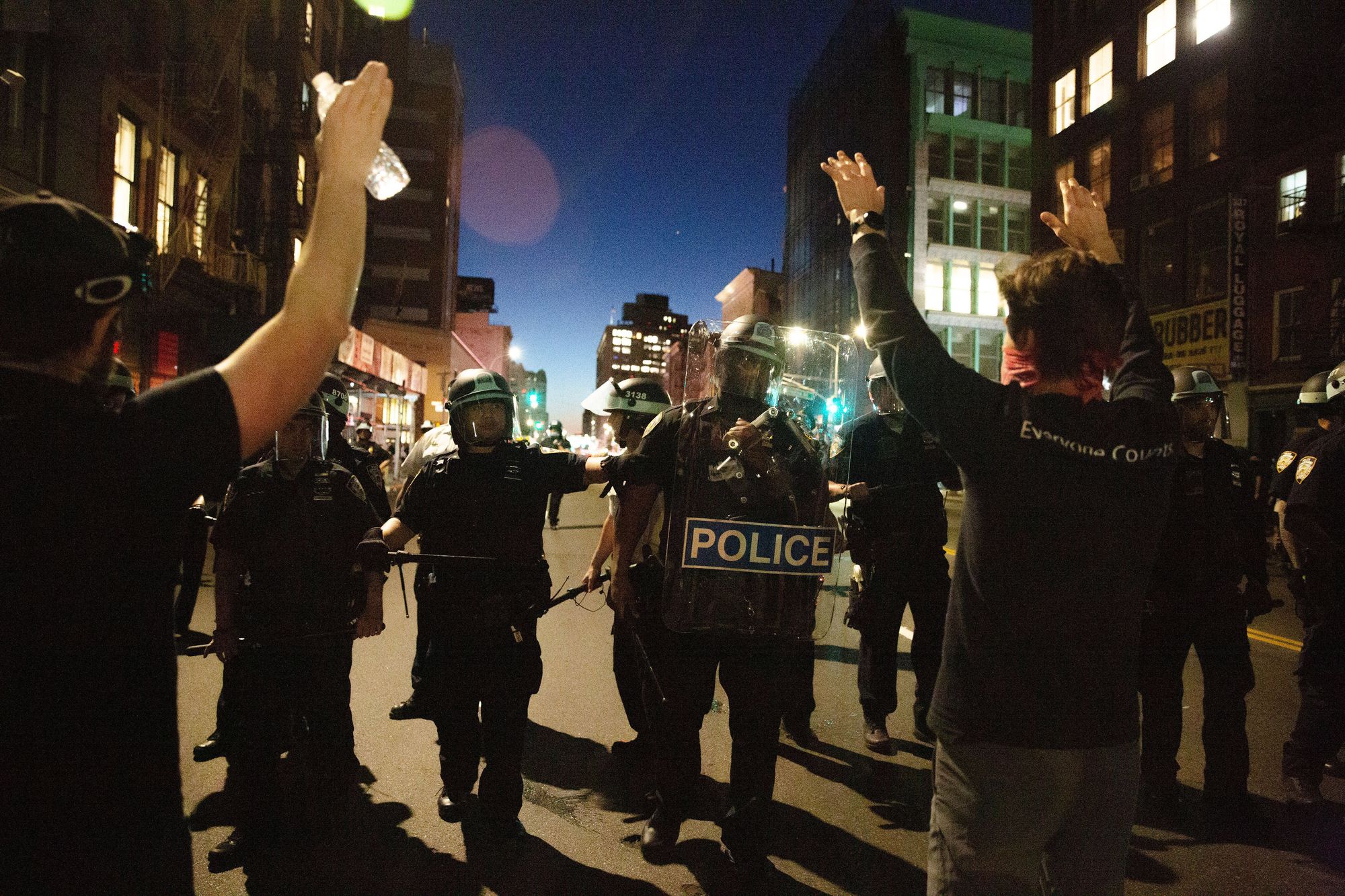 Tensions grew in lower Manhattan on Sunday evening as police surrounded protestors, using batons to disperse them. 
