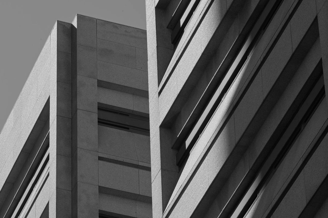 A black-and-white photo shows a concrete structure with narrow horizontal windows. 