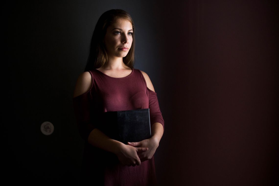 Kimberly Heraldez holds the ashes of her father, Kevin Zeich, who died of cancer in prison, at her home in Bakersfield, Calif.