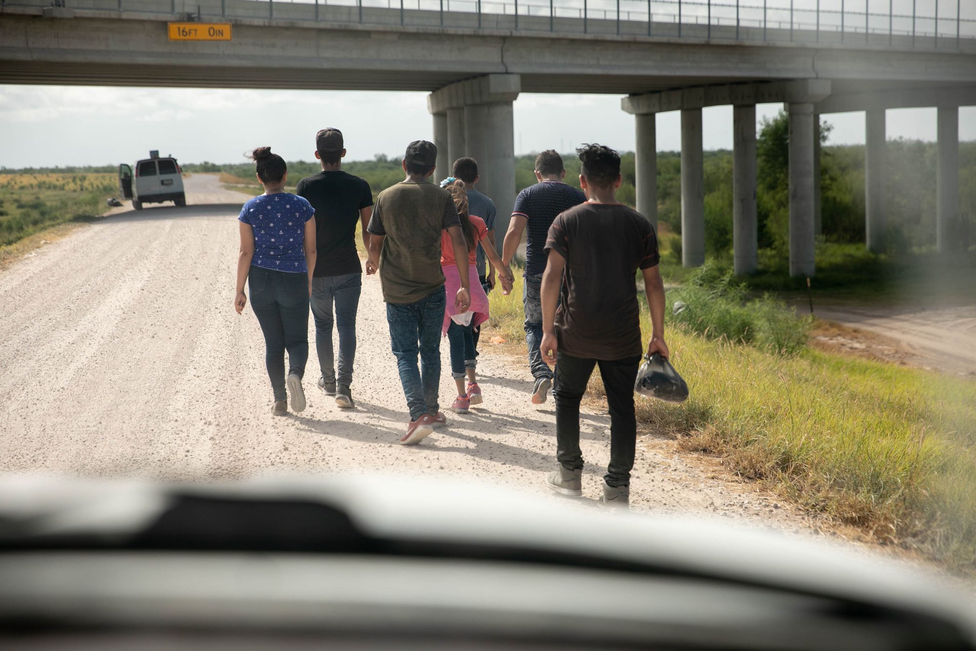 A group of migrants, including adults and children, who turned themselves in to the Border Patrol near Mission. After an outcry about family separations, parents with their children are no longer sent for criminal prosecution in federal court under zero tolerance. 
