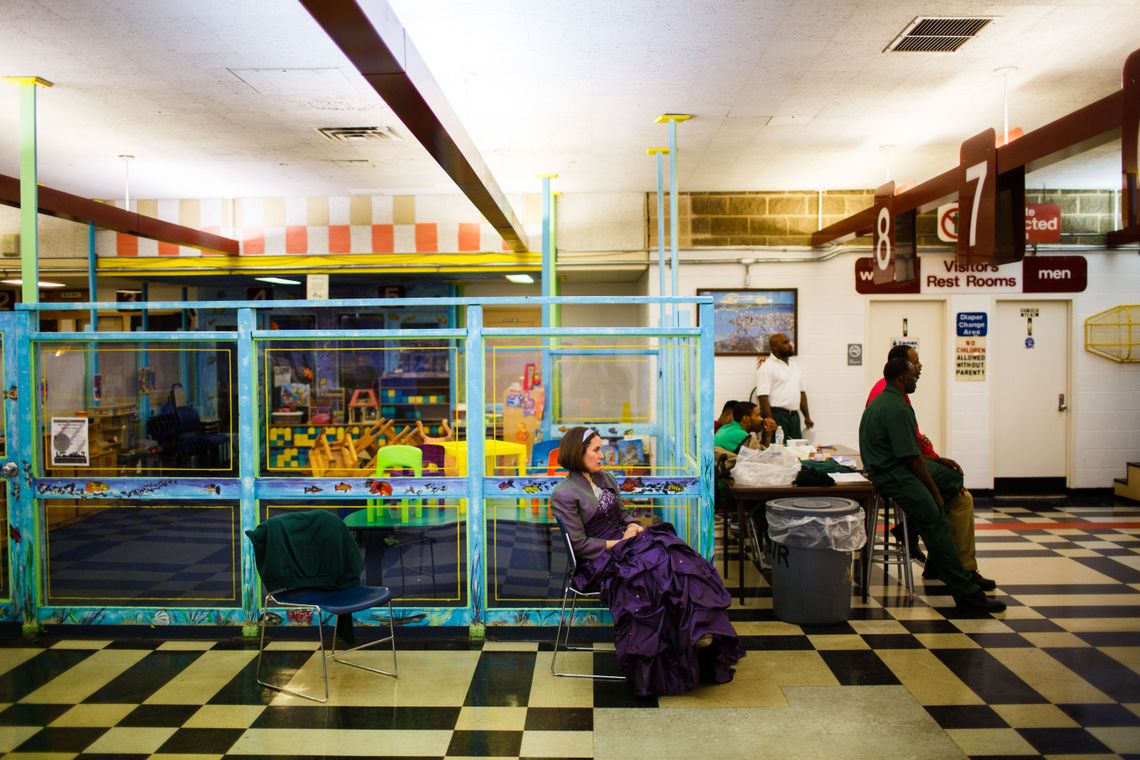 The performance took place on a stage set up in the middle of Sing Sing’s visitors’ room. Dawn McDonald, who played Olivia, waits beside a play area for children who visit their parents at the prison.