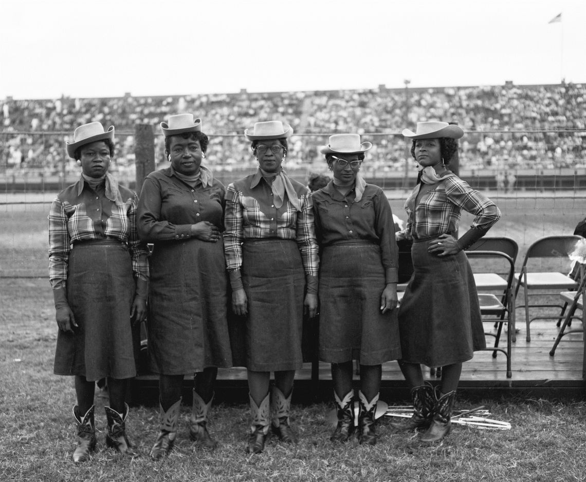 Members of an African American musical group from Goree strike poses in their full Western dress.