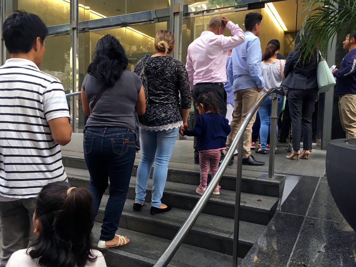 People line up outside the building that houses the immigration courts in Los Angeles in 2018. 