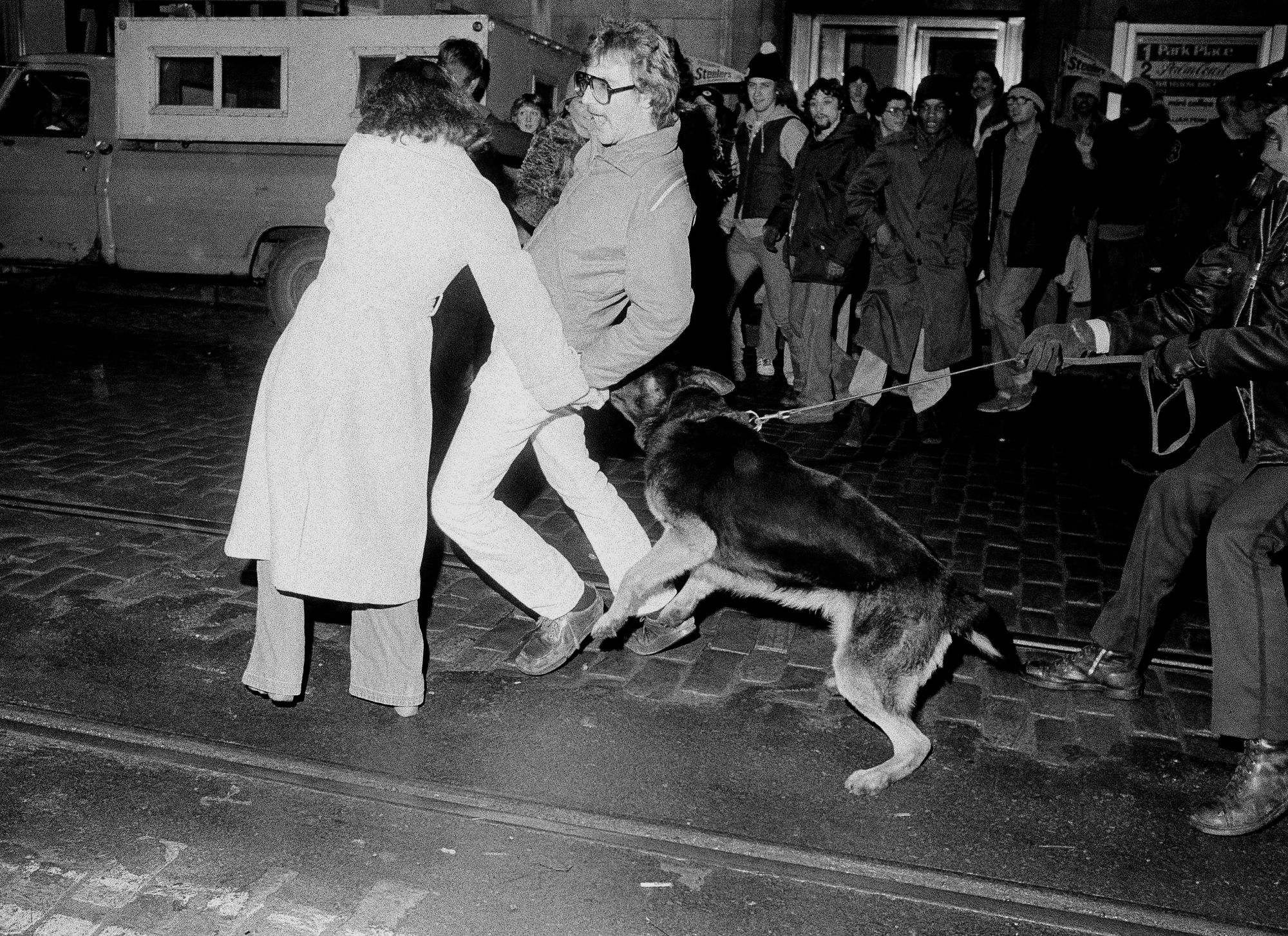 A police dog attacks a Steelers fan during the celebration of the team’s Super Bowl victory in downtown Pittsburgh, Jan. 22, 1979. 