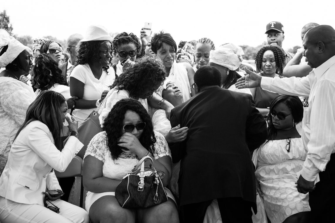 Family members weep as the casket of Alexander Kamara is lowered into the ground on Saturday, July 21, 2012. Kamara, 16, was a promising student and soccer player who wanted to go to college. He was killed in the crossfire of a shooting that took place during an afternoon soccer tournament in Wilmington, Del.
