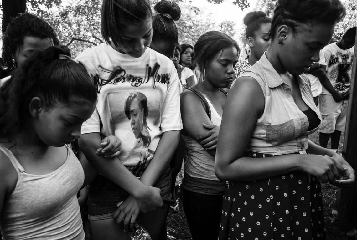 Women pray on June 29, 2013, the one-year anniversary of or Qua’Nyrah Houston’s death. 
