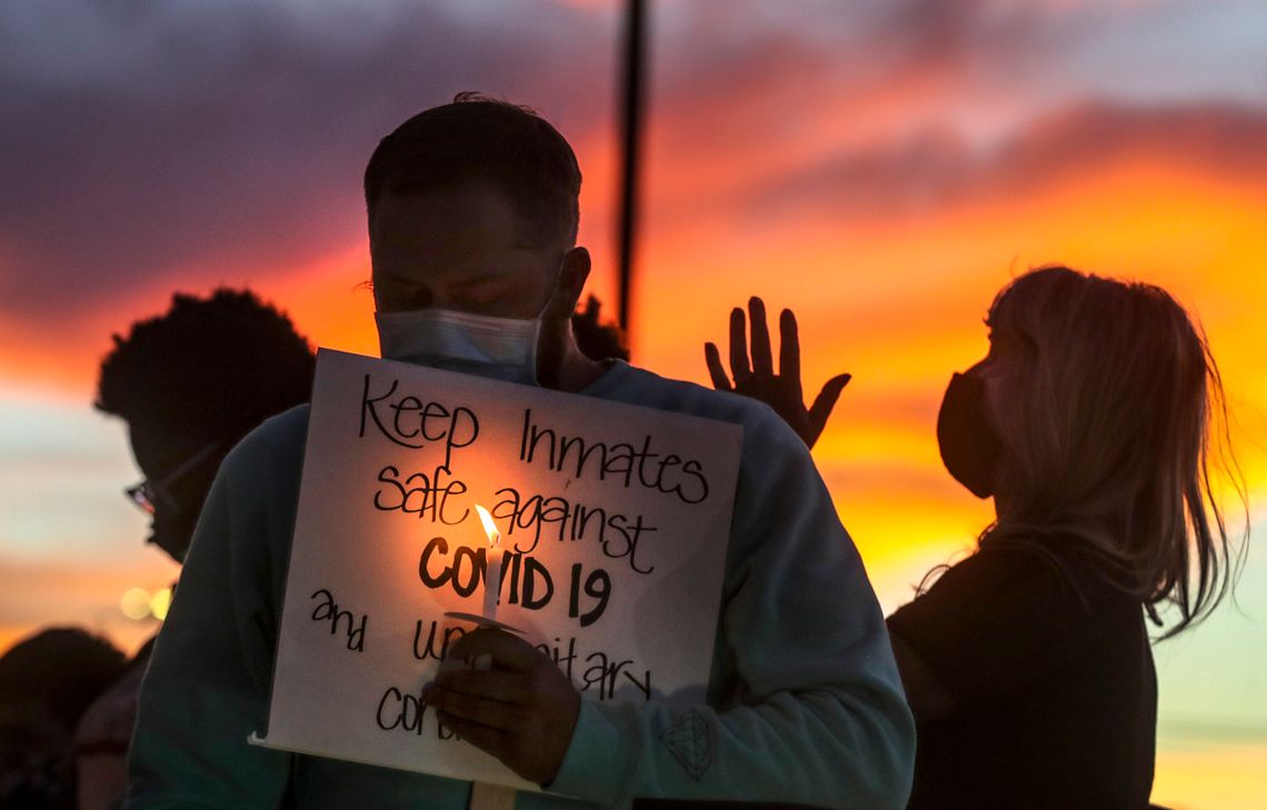 Family members of people incarcerated in Utah prisons held a vigil outside the state Department of Corrections office. 