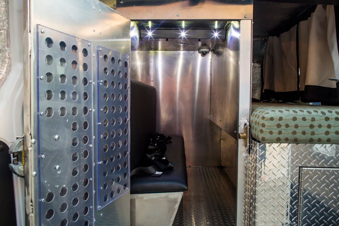The updated front holding compartment in a Prisoner Transportation Services van. The compartment no longer contains a metal door that isolates a single seat.
