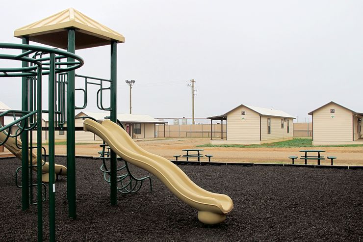 A playground surrounded by cottages that will house immigrants at a new family immigration detention center in Dilley, Texas, on Monday, Dec. 15, 2014. Opening following a summer surge of children crossing the U.S.-Mexico border illegally, the compound features cottages and will have an initial capacity of 480 growing to 2,400 around May _making it the nation’s largest family immigration lockup. (AP Photo/Will Weissert)