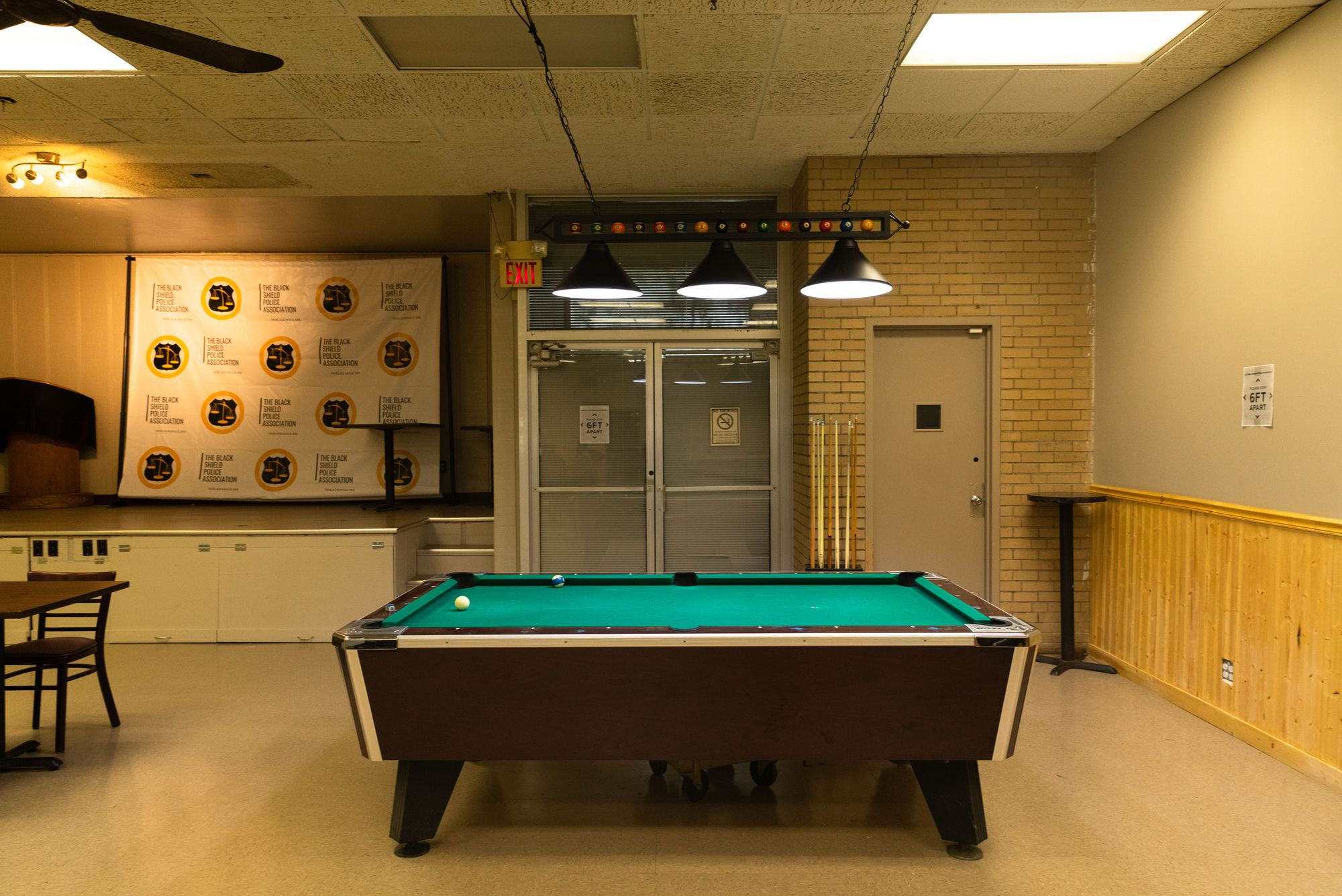 A room featuring a pool table. 
