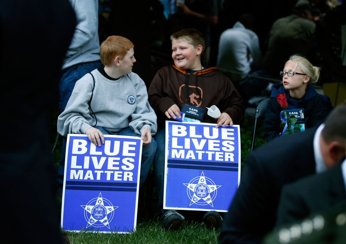 Two boys attended the National Law Enforcement Officers Memorial Fund’s annual candlelight vigil in 2015.