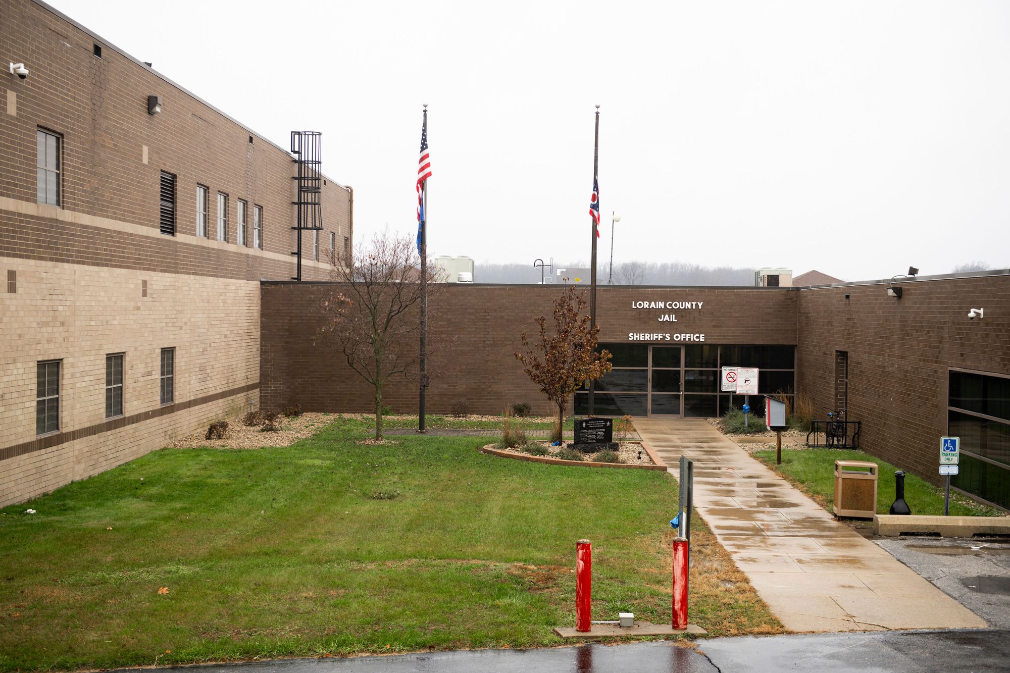 The exterior of the Lorain County Jail and Sheriff’s Office, a brown brick building, on an overcast day. 