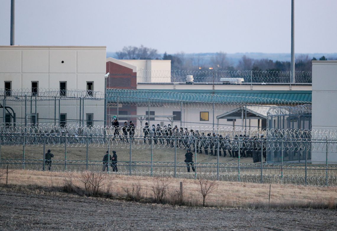 Security forces in riot gear amassed to confront dozens of incarcerated people who refused to return to their cells at Tecumseh State Correctional Institution in 2017.