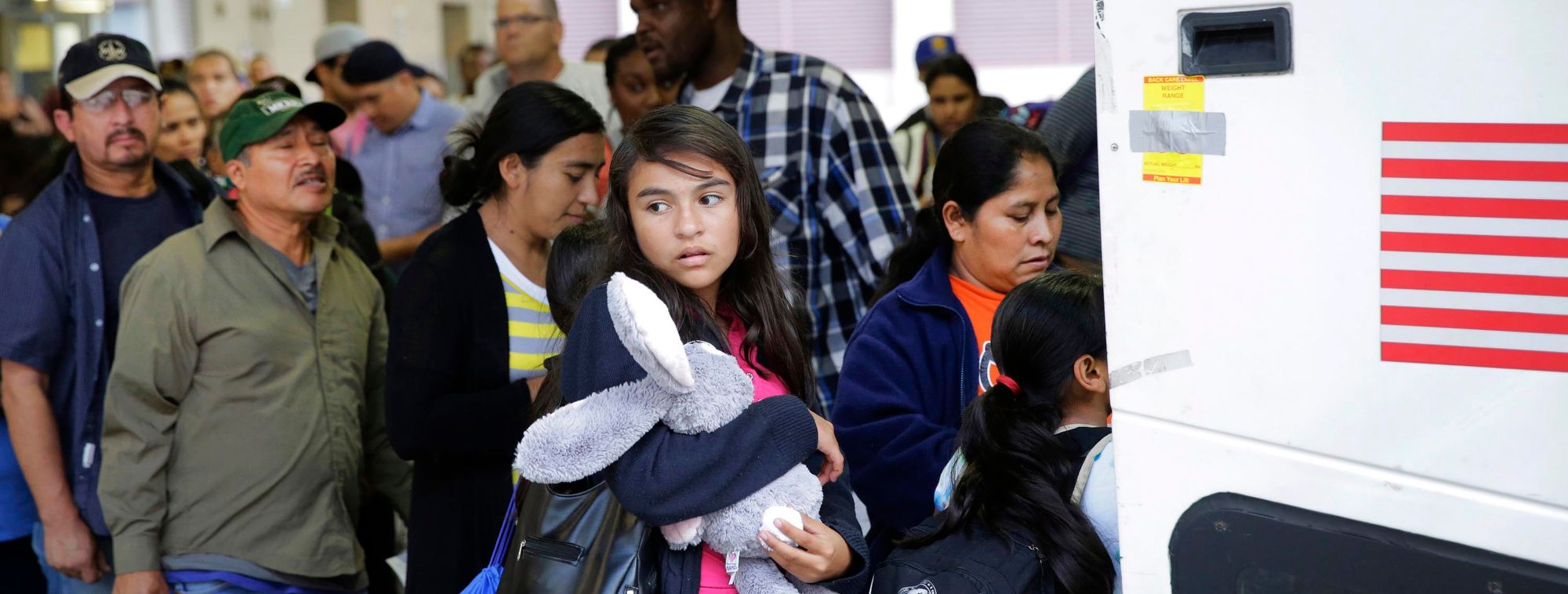 Immigrants from El Salvador and Guatemala board a bus after being released from a family detention center in Texas. 