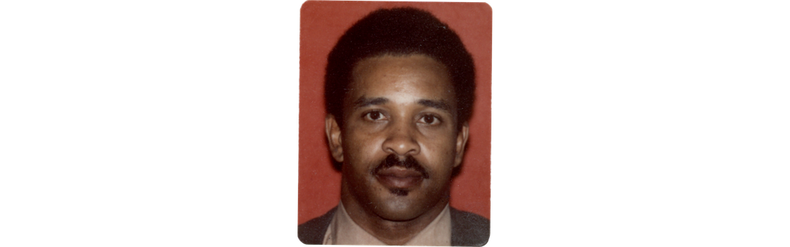 A headshot of Clark Kellogg, a Black man wearing a beige shirt and gray jacket. 