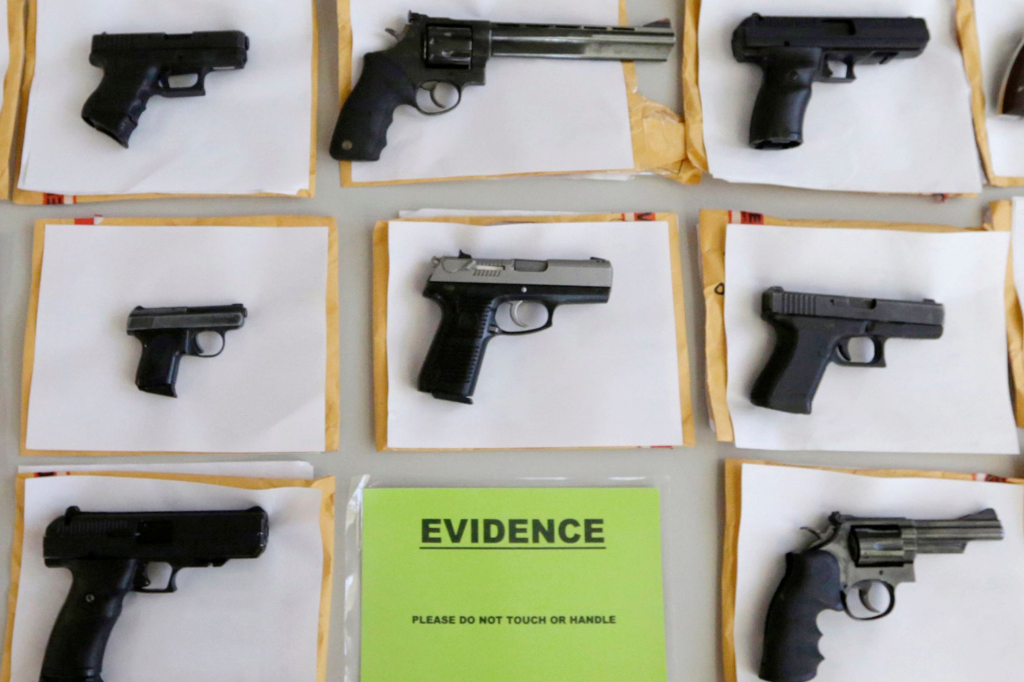 FILE - In this July 7, 2014 file photo, Chicago police display some of the thousands of illegal firearms they confiscated during the year in their battle against gun violence in Chicago. At a news conference Tuesday, March 1, 2016, Chicago police said there have been about twice as many homicides and shootings so far this year in Chicago as compared to the same period in 2015, but the number of illegal guns seized has dropped. (AP Photo/M. Spencer Green, File)