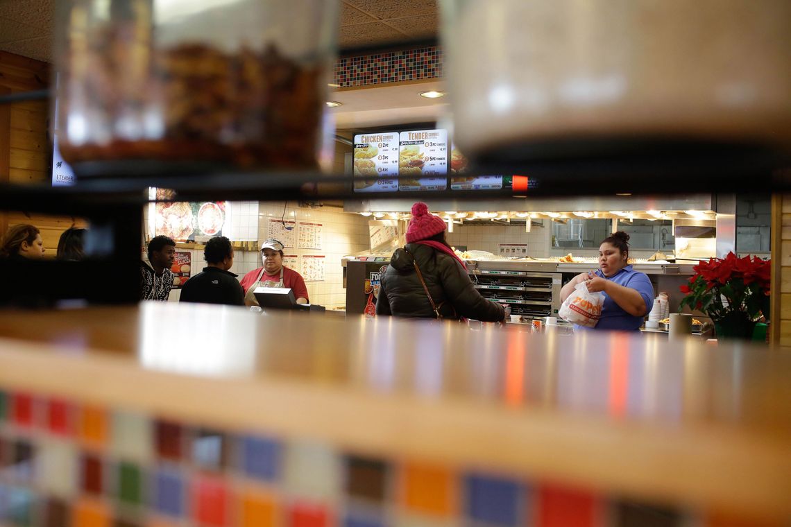 Patrons wait in line at Popeye’s restaurant near the Cook County Jail in the Little Village neighborhood.