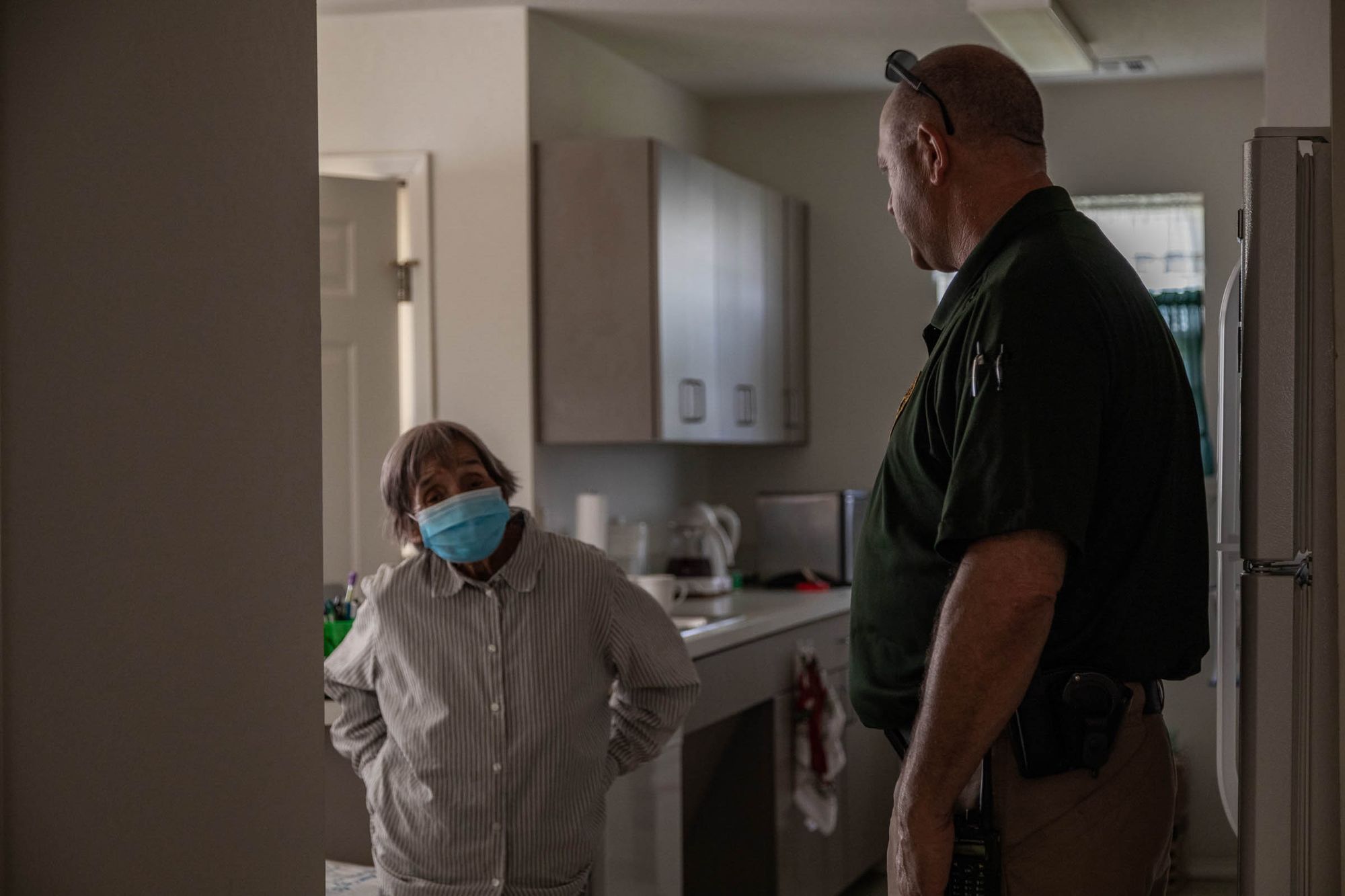 Lighthorse Police Officer Robert Frost talks with a resident of the tribe's senior housing in Okmulgee.