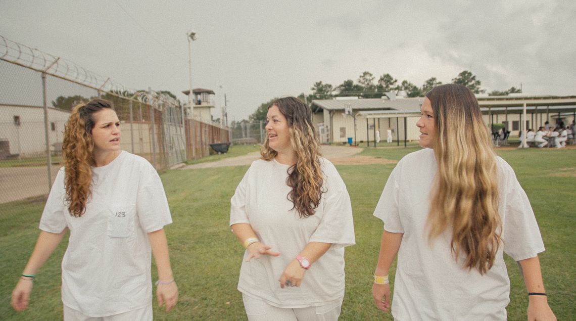 Women who recently gave birth walk around the prison grounds.