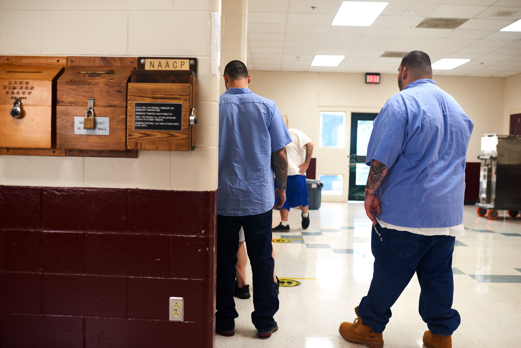 People incarcerated at Maine State Prison wait in the 6:30 a.m. med line on July 28, during which some receive methadone or buprenorphine to combat opioid addiction.