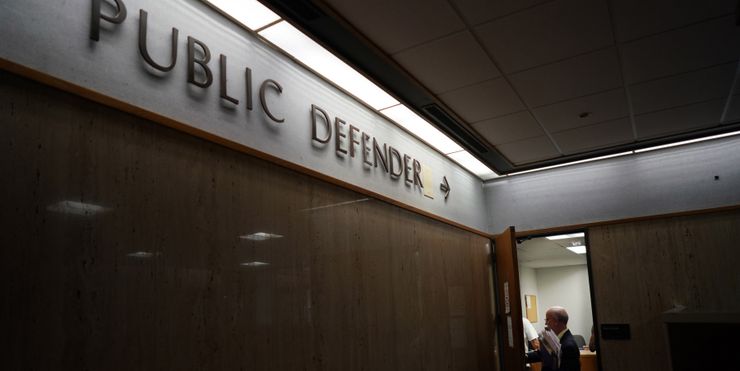 A public defender returns to his office after helping defendants at the Rhode Island District Court in 2017. 
