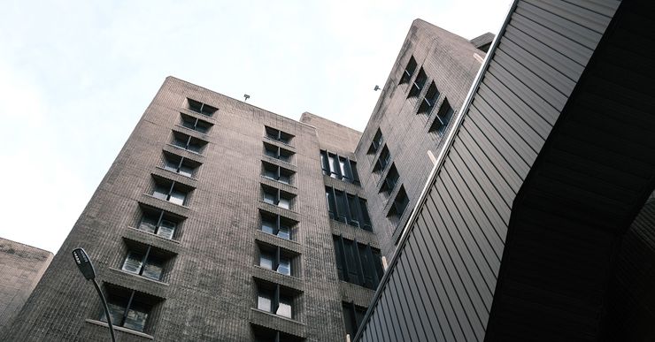 A dark brown high-rise federal prison. 