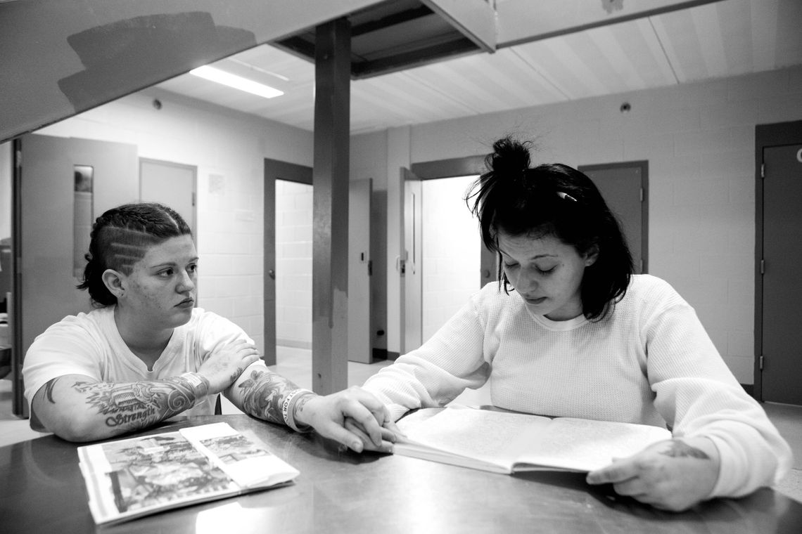 Michelle Blaney, left, holds her cousin Stephanie's hand while she reads an "impact letter," written to herself from the perspective of her 5-year-old son. "I'm scared for you, Stephanie. There are fuckers out there who are going to give [heroin] to you for free," said Blaney while Stephanie talked about her impending release.