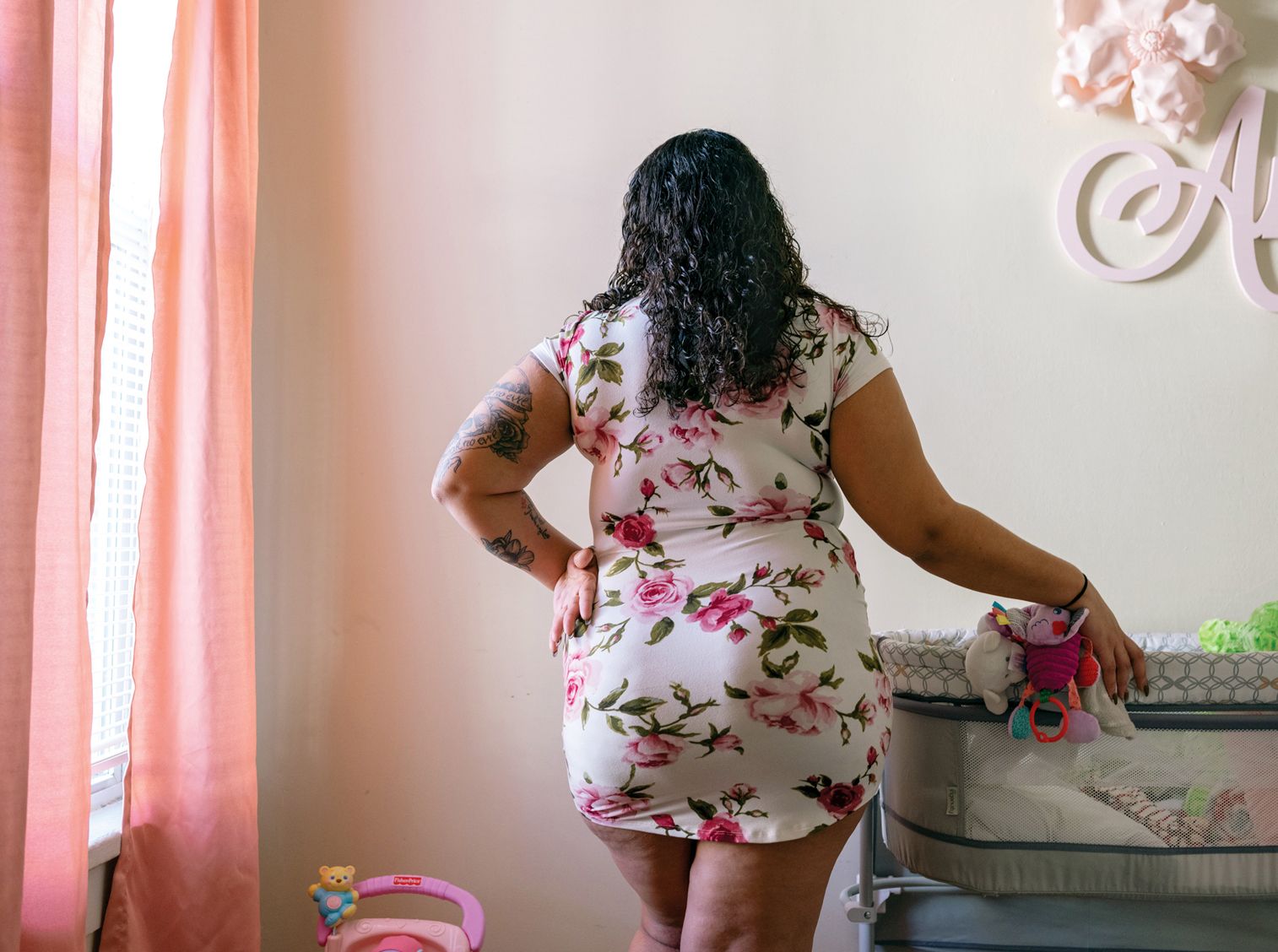 M., 23, stands in the room she has prepared for her daughter at her home in Massachusetts in March of 2021. Since her newborn daughter was placed in foster care, M. has been forced to bond with her primarily through Zoom.