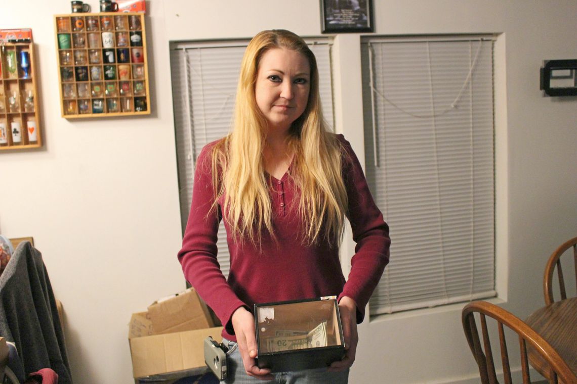 Kristina Howell holds her “get out of jail box” for money that goes toward paying the cost of fees relating to her case. 