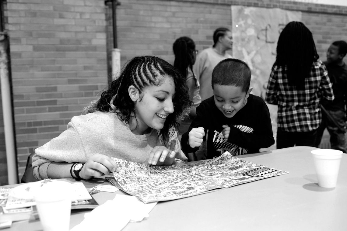 Limari and her son Elijah try to find Waldo in a book together.