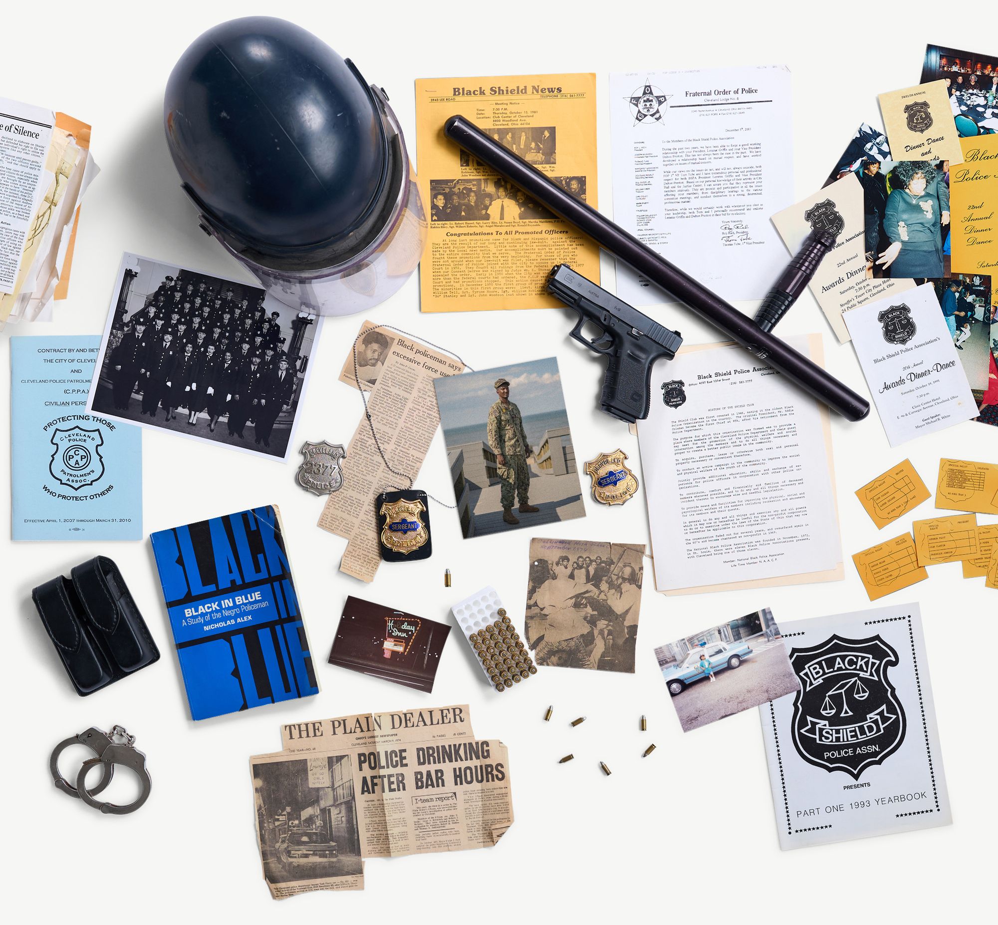 A collage of items related to policing, the Black Shield Police Association and the author’s family. The items include: a police helmet; a baton; a gun; bullets; a sergeant’s badge; a newspaper clipping related to police misconduct and another related to use of force by police; and a photo of former police officer Vincent Montague. 