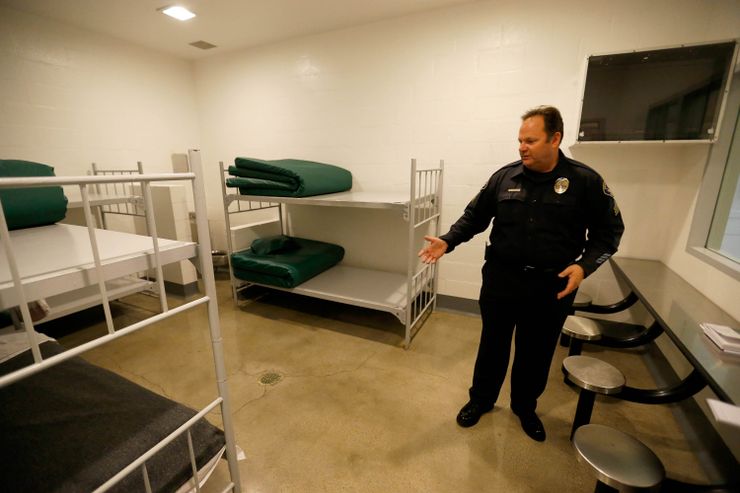 Sgt. Steve Bowles of the Seal Beach Detention Center in Seal Beach, Calif., gives a tour of a jail dorm where pay-to-stay participants can watch television.