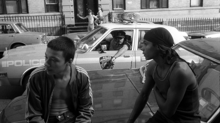 New York City police officers stop to observe two young people, who were not selling drugs but were hanging out on a known drug corner in the Bronx in the 1980s.