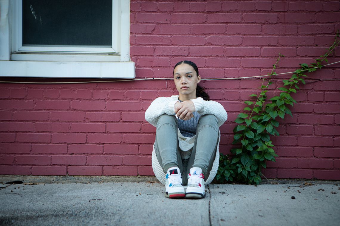 Brianna Stuart sits near the building where she encountered police in September 2016 on Oct. 8, 2021.