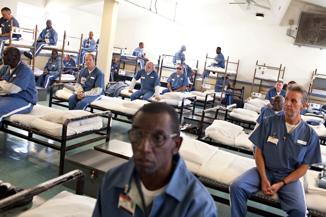 Prisoners wait for a morning head count at the Sumter Correctional Institution in Bushnell, Fla.