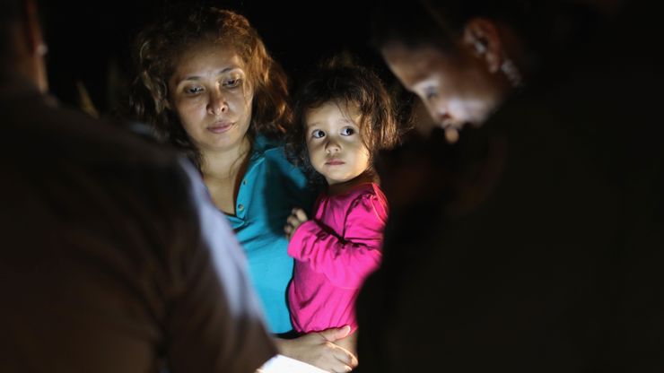 Central American asylum seekers, including a Honduran girl, 2, and her mother, are taken into custody near the U.S.-Mexico border in June in McAllen, Texas.